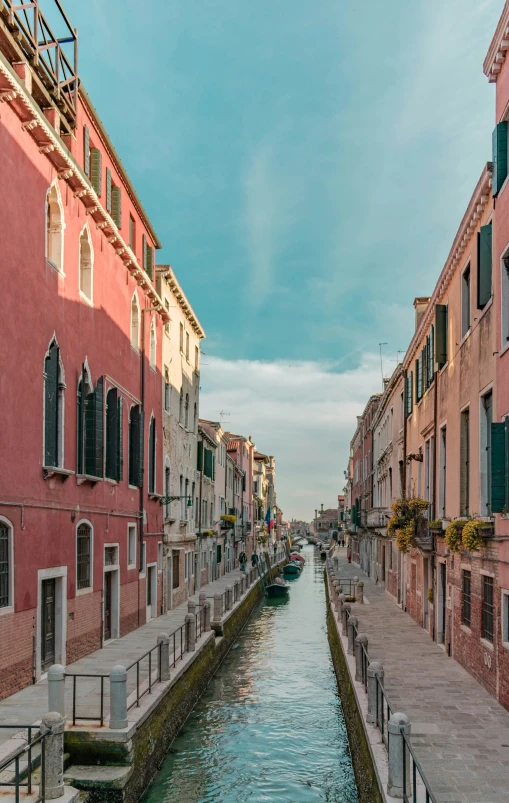 a waterway in venice during the day with several boats