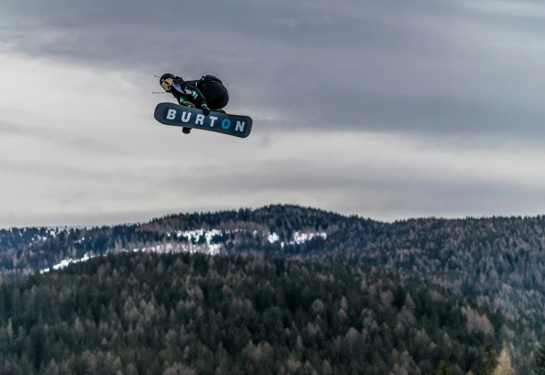 an individual is performing a stunt on a snowboard