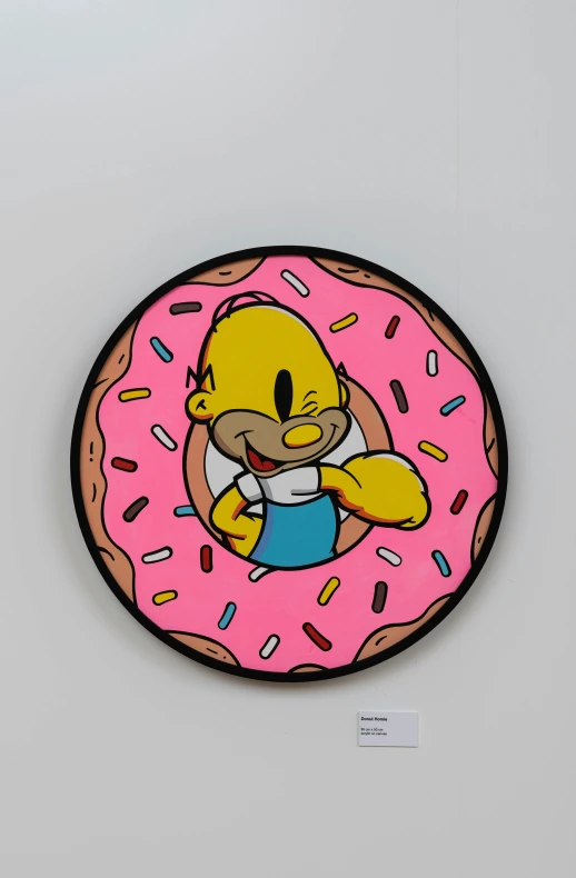 a cartoon is displayed on the back of a big pink doughnut