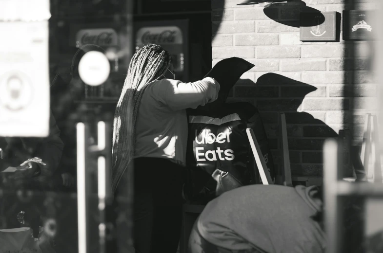 a person walking into a store window with a hat on