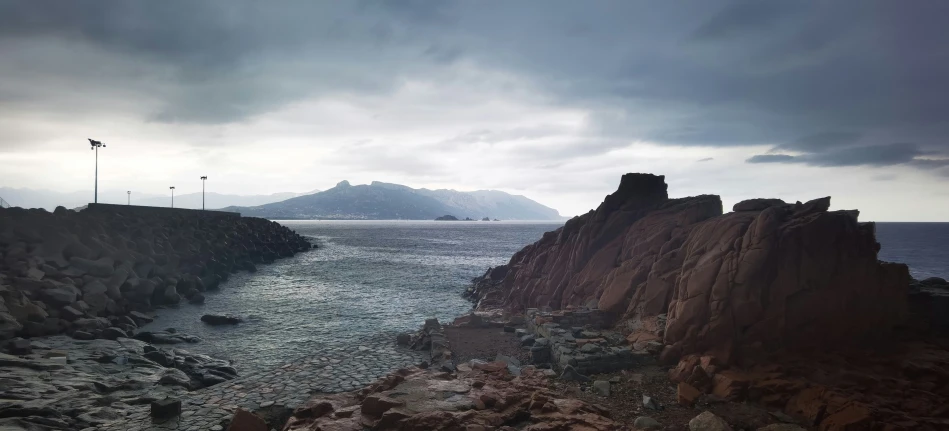 a large body of water with mountains in the background