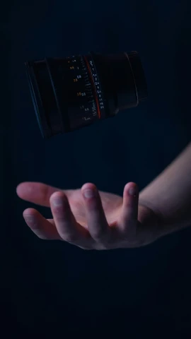 someone's hand extended to catch a camera