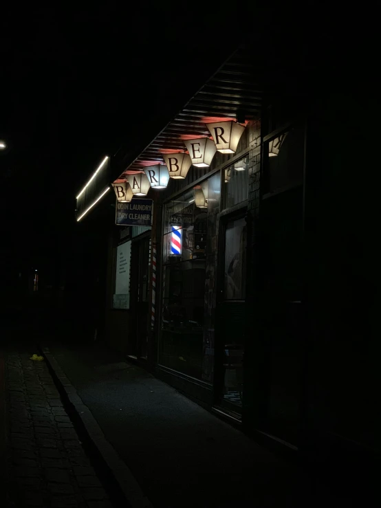 a man walking down a street in the dark