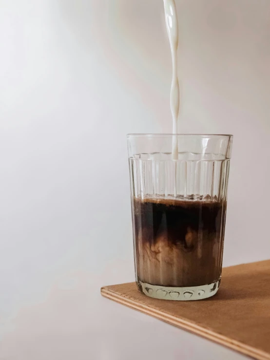 a liquid pour into a glass filled with liquid