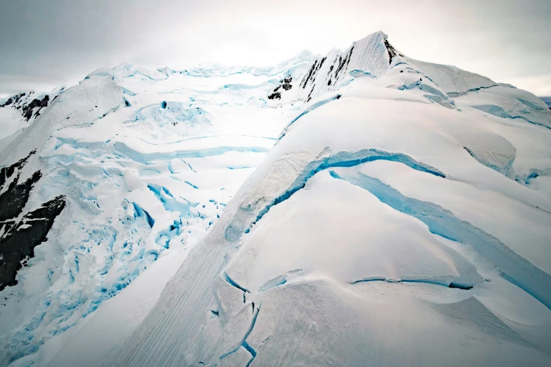 a skier is sliding down the side of a mountain