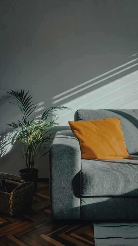 a sofa next to a wall in a room with a chair