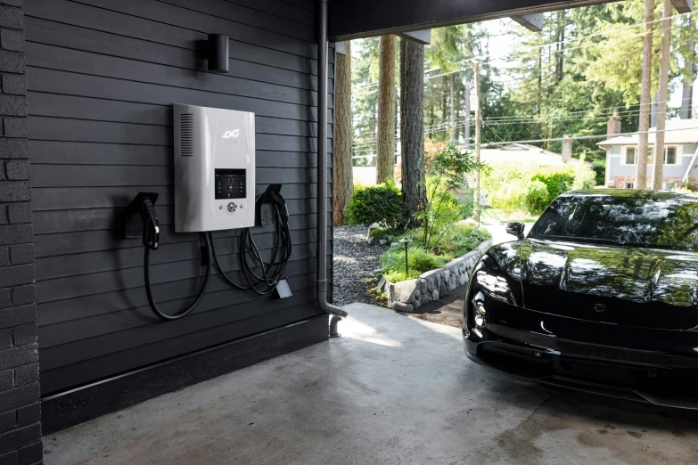 an electric car plugged into an outlet in a garage