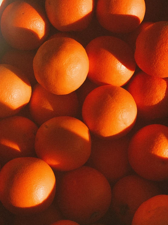 a group of oranges on display in a bowl