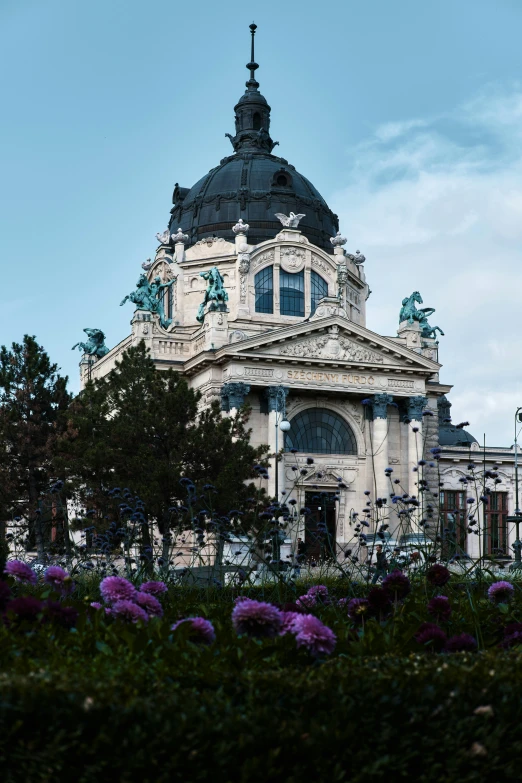 the building is very large and has flowers in front