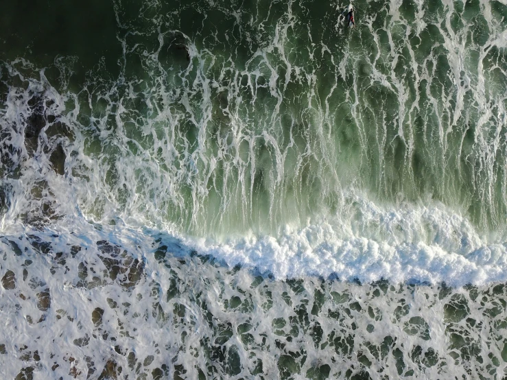 a man is surfing near the top of a wave