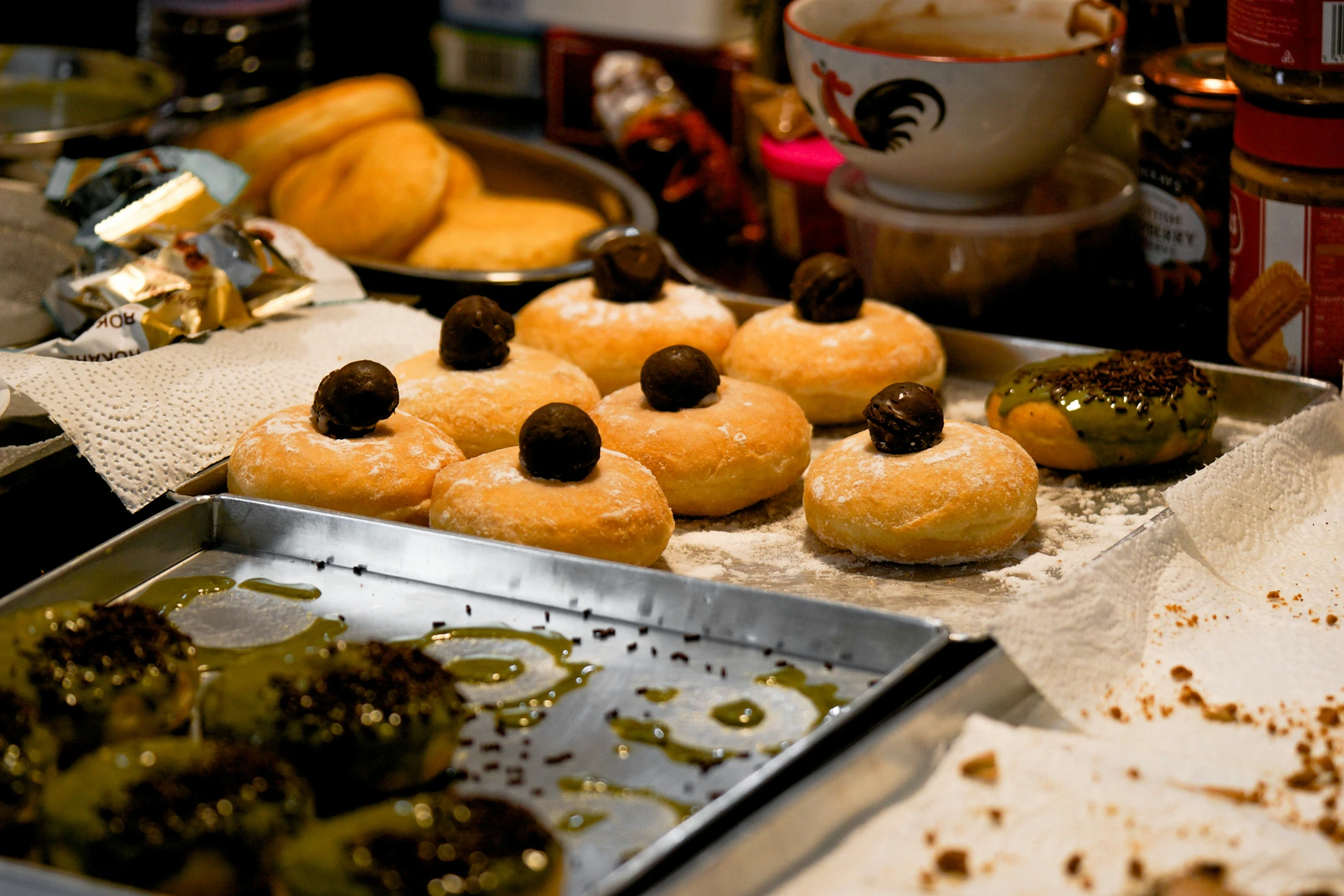 some trays filled with donuts that have toppings on top