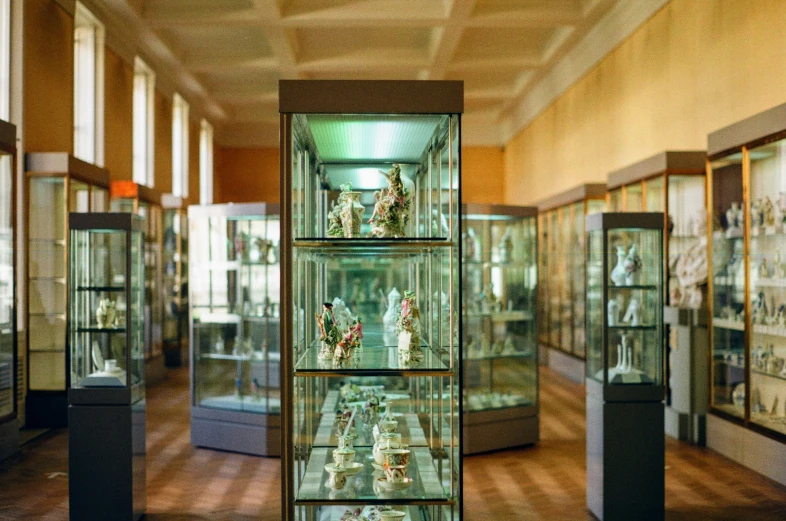 glass cased shelves with many small figurines inside