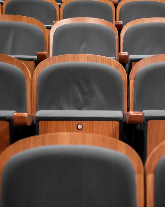 grey chairs lined up behind each other with wood frame