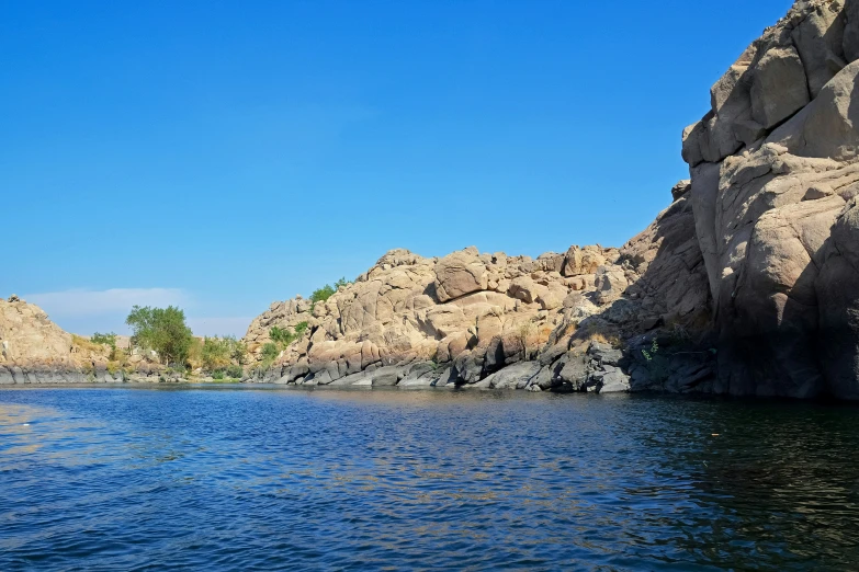 a view from the back of a boat as it passes some rocks