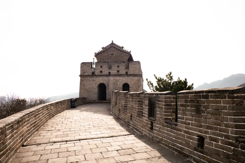 a stone and brick walkway between two towers