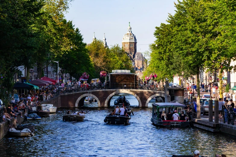 many people are going down the canals in boats