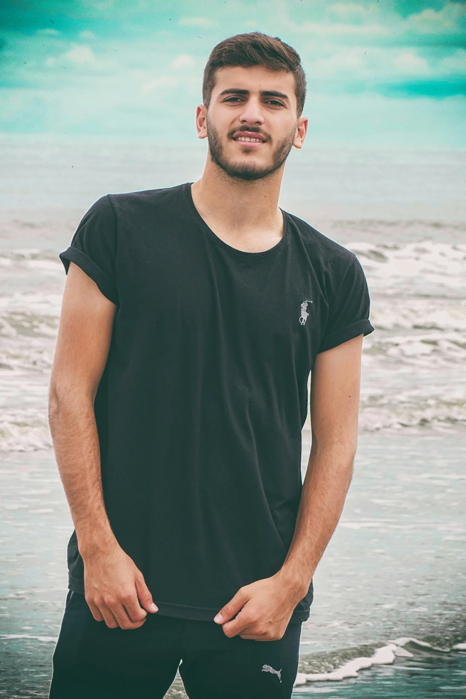 a man standing in the water by the beach