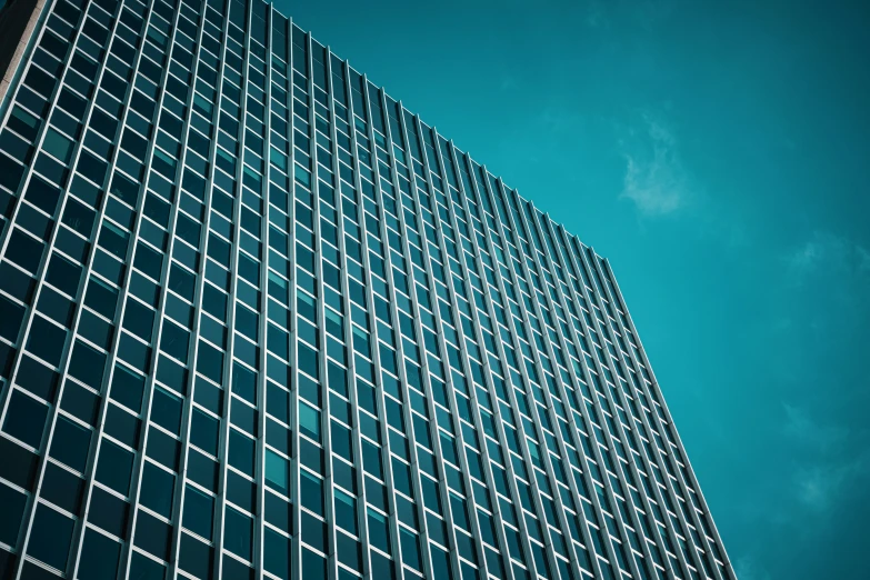 an architectural building is shown against a blue sky