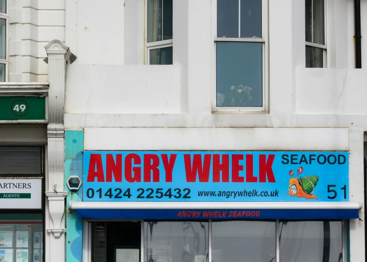 an angry wheyk seafood restaurant on the corner of a building