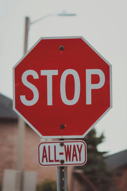 a red stop sign on top of a small red sign