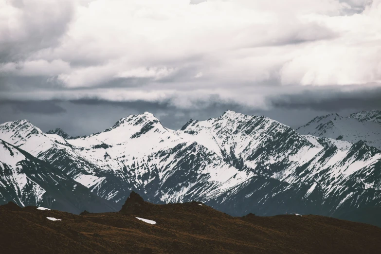 an uphill view of some mountains covered in snow