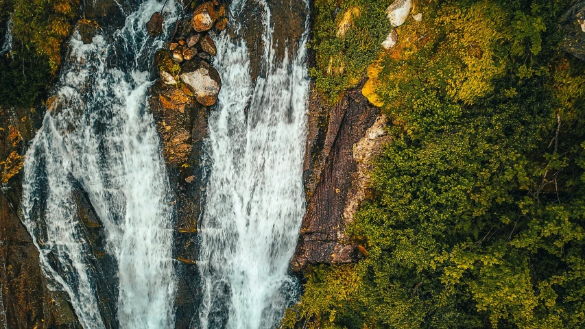 the waterfall in the forest is very tall