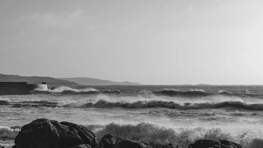 a small lighthouse is at the top of a hill