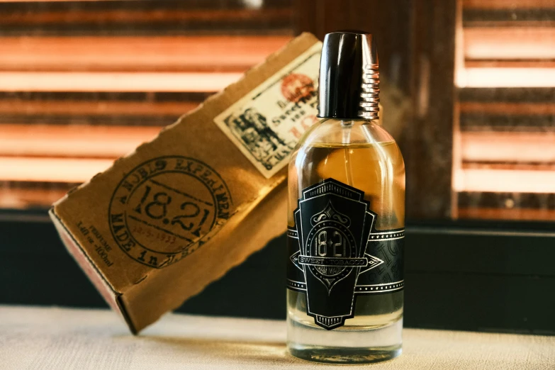 a small bottle of alcohol sitting on a counter next to a paper bag