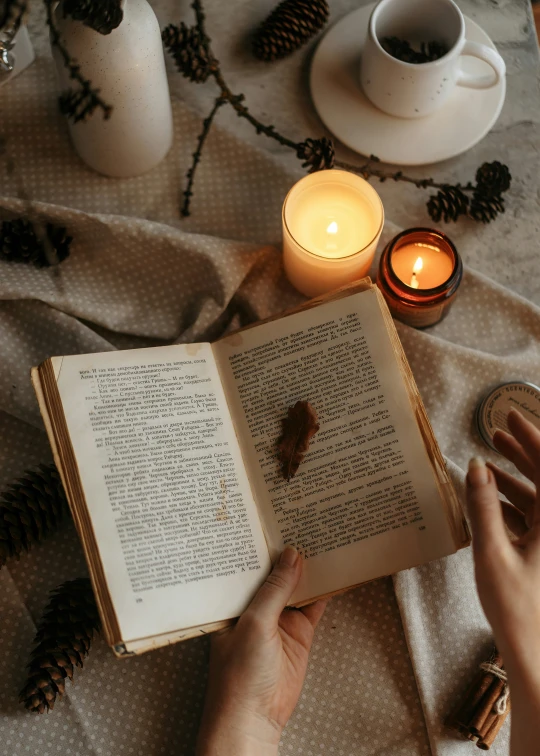 a person sitting on a table with an open book