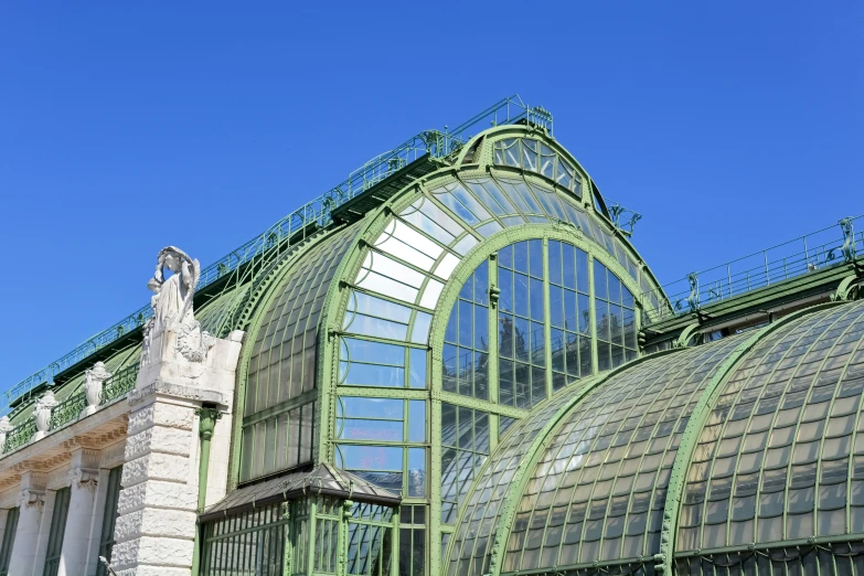 the building has multiple glass windows and is covered in intricate architectural work