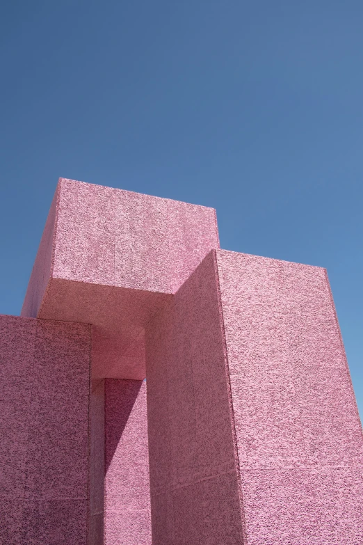 an image of a pink abstract sculpture on the side of the building