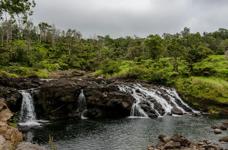 a small waterfall flowing down a large body of water