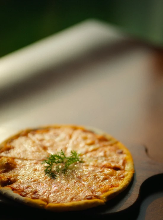 a small pizza on a wooden  board