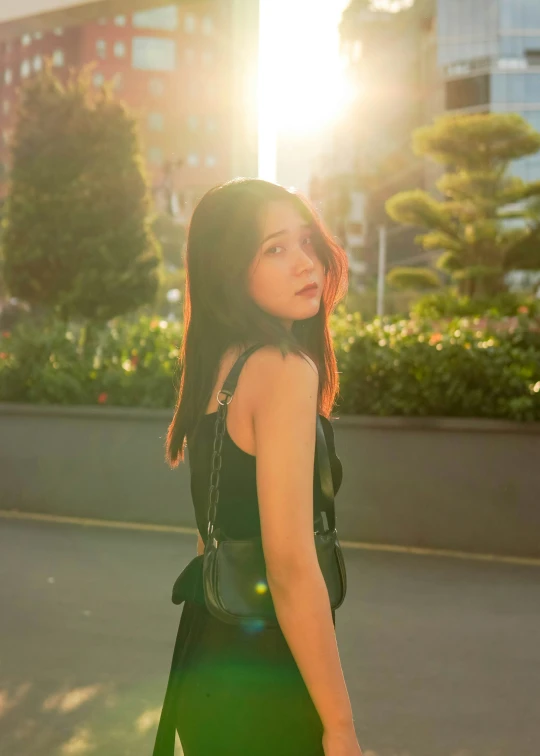 a woman is walking down the street with her back towards the camera