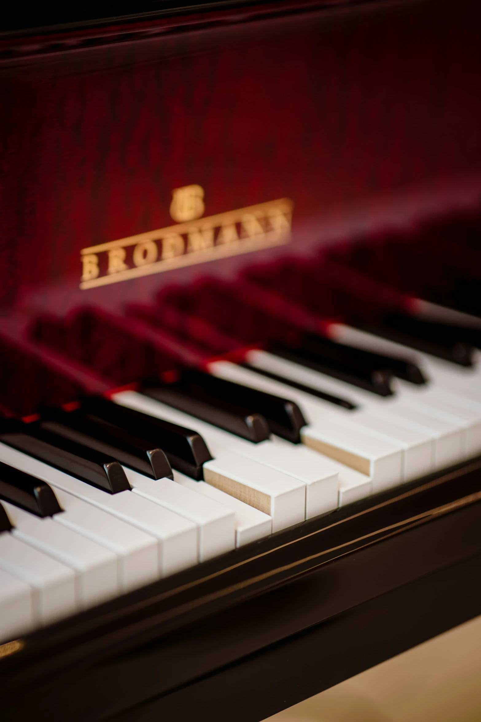 the keys of an old piano with a red case