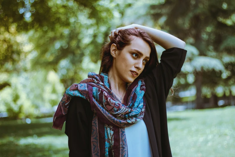 a woman with her head against the tree nches