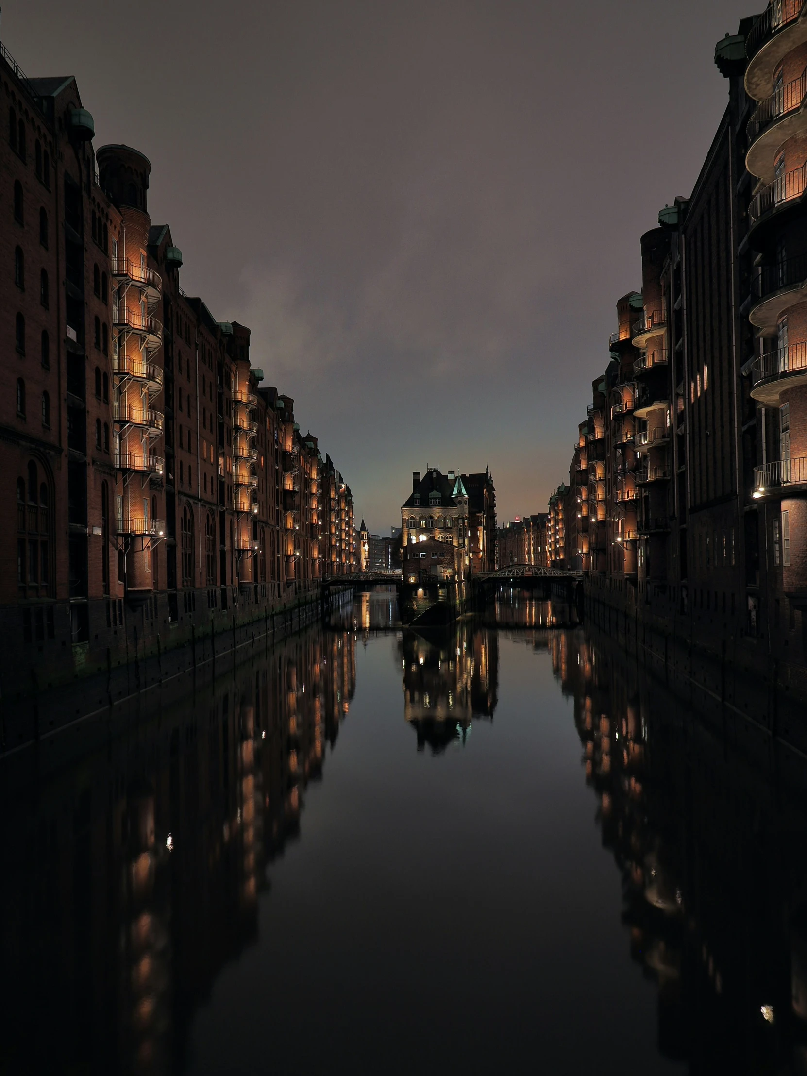 an empty waterway leading down to an urban area