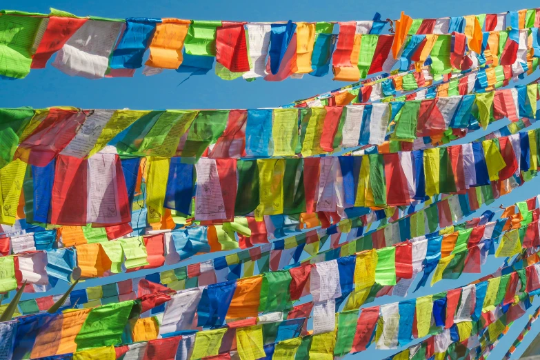 many colorful flags are strung up in a row