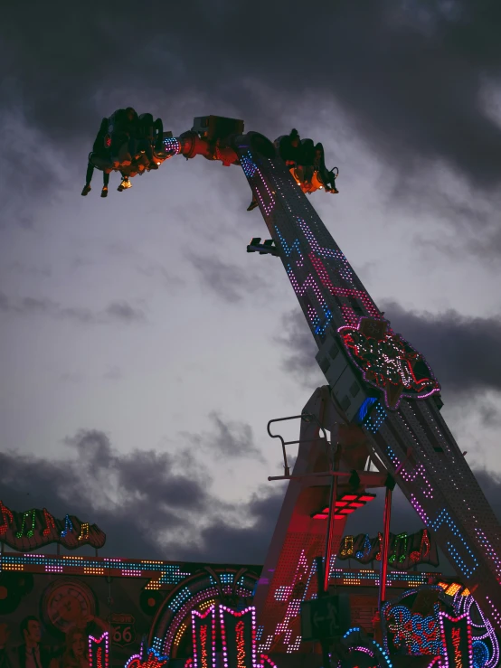 a roller coaster with lights in the sky