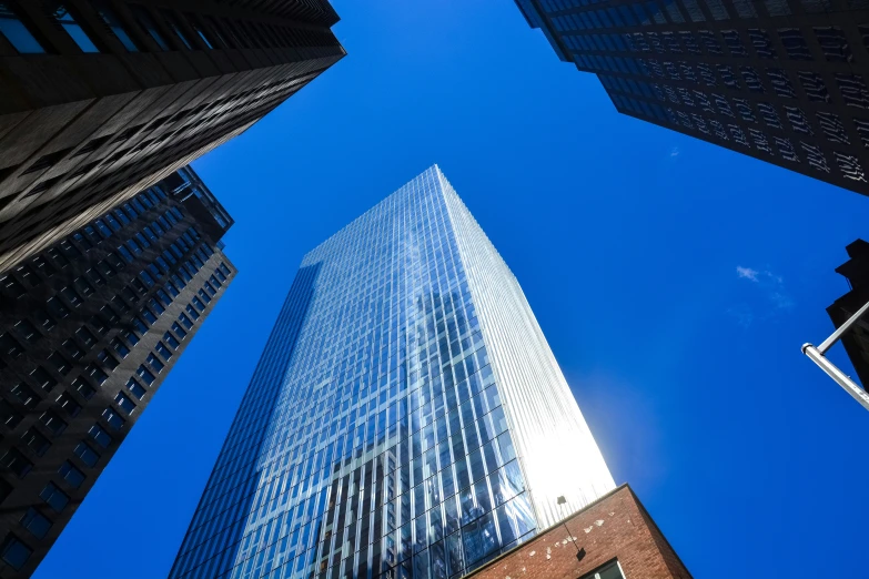 several tall buildings stand against the blue sky