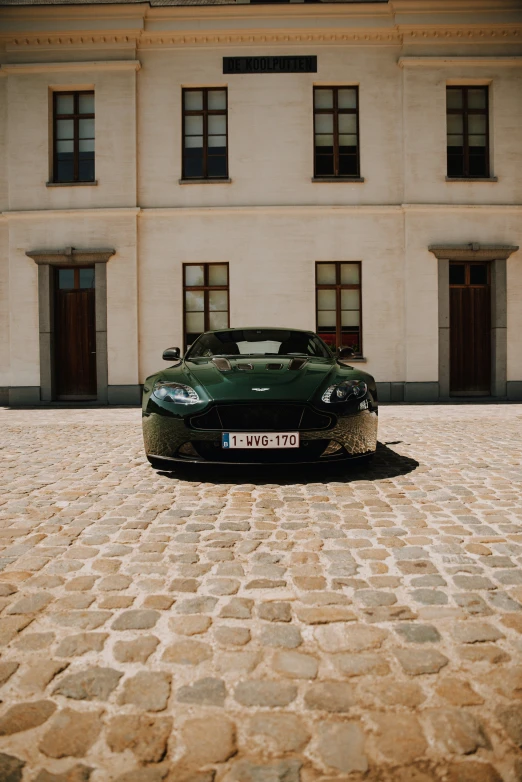 a black sports car parked in front of a house