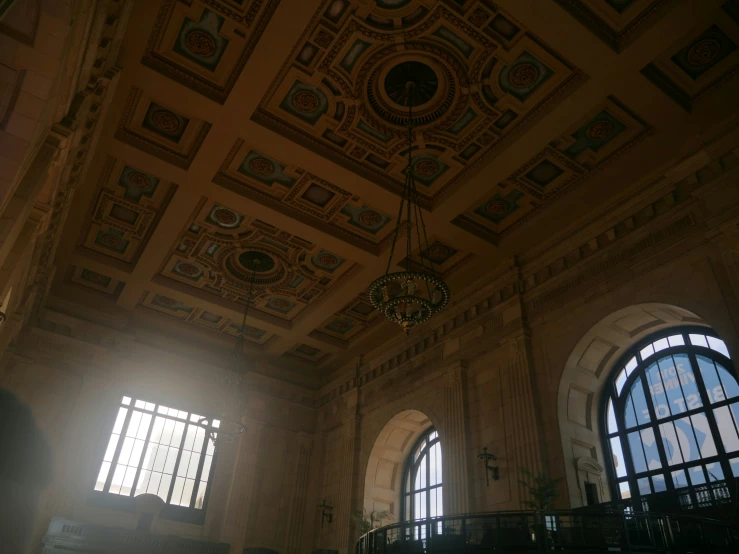 an ornate ceiling and windows with a chandelier