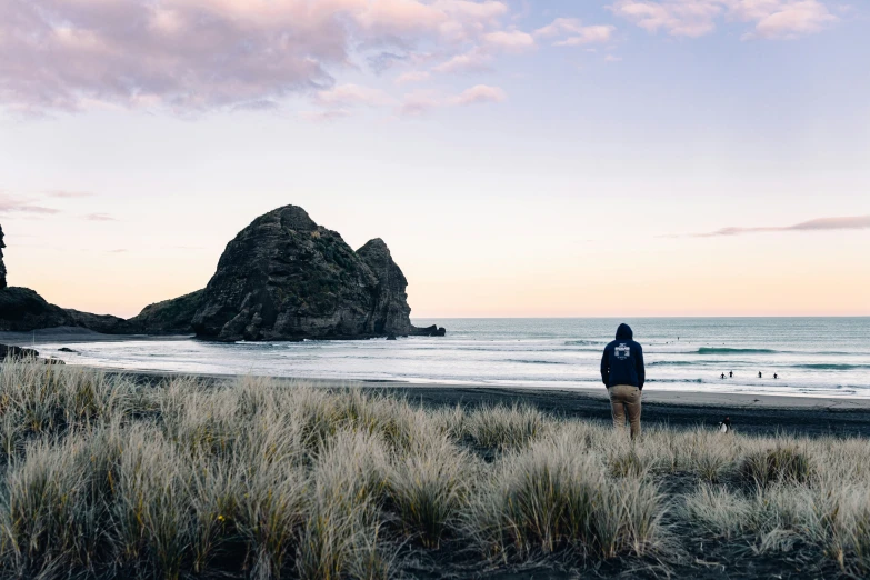 a man standing on top of a sandy beach