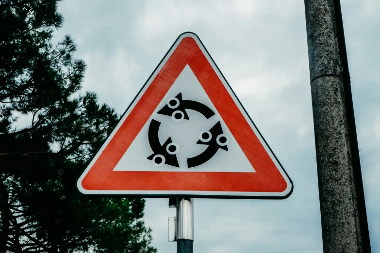 a warning sign with an image of a couple of fish and a circular circle