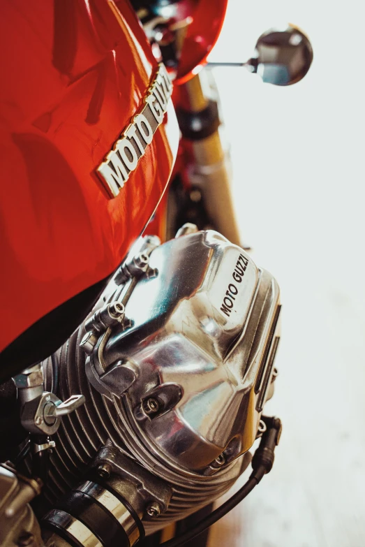 a closeup of the front wheel of a red motorcycle