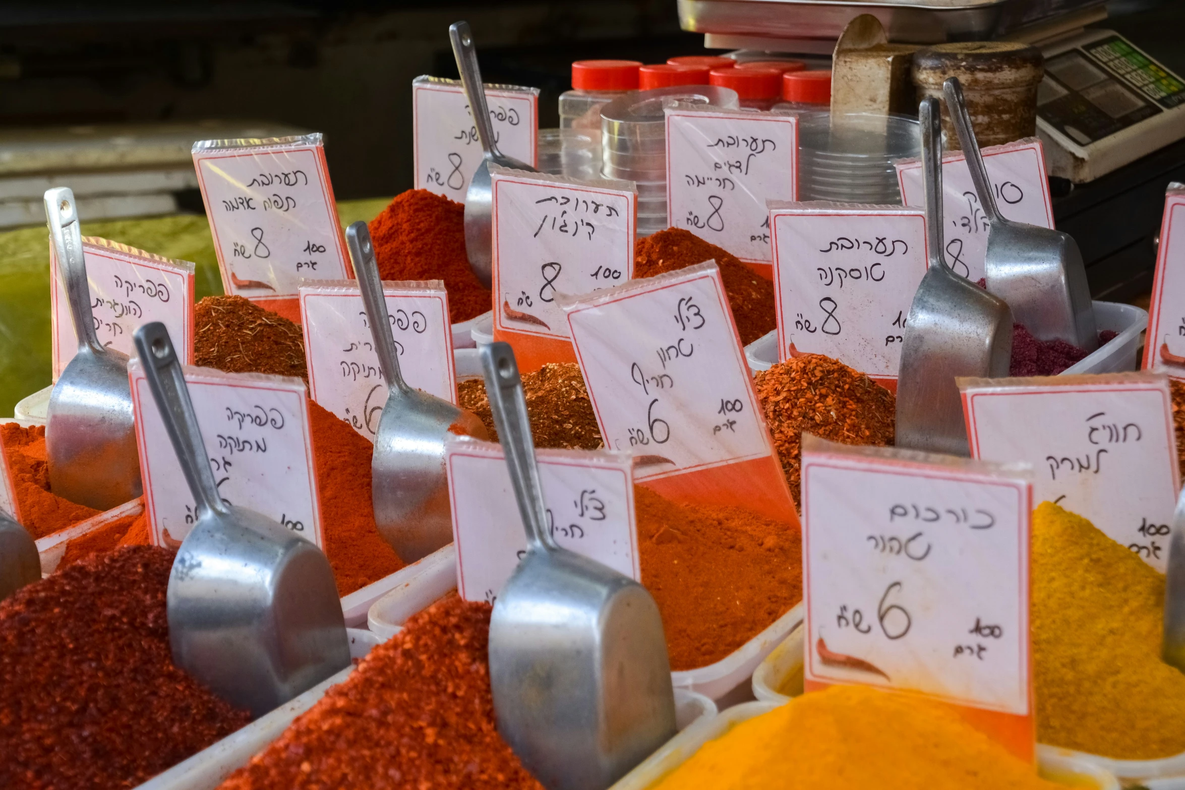 spoons, spices and other condiments on display at a grocery store