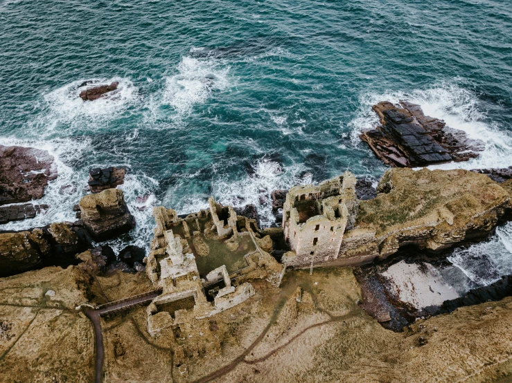 an aerial s of rocks and water near the ocean