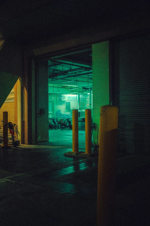 an empty parking garage at night with a neon sign lite up