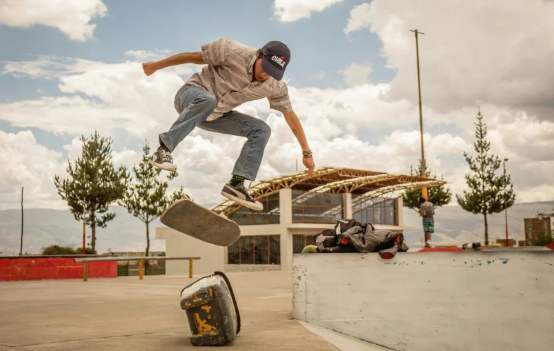 a skateboarder who is jumping over some metal