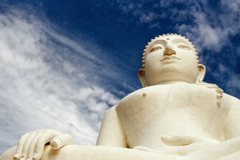 the statue is sitting in front of the blue sky